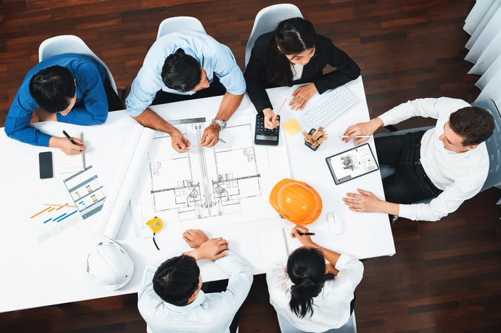 Aerial shot of consultants sat around a table