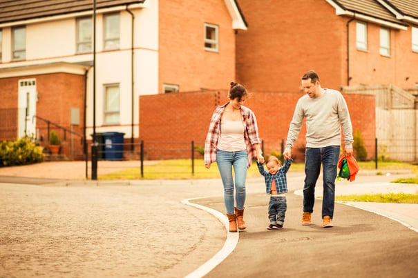 young family walking with child