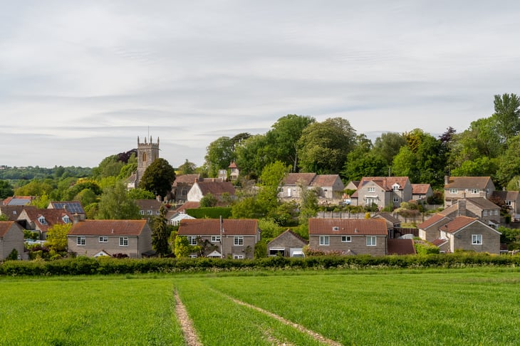 Stock image of housing estate behind field