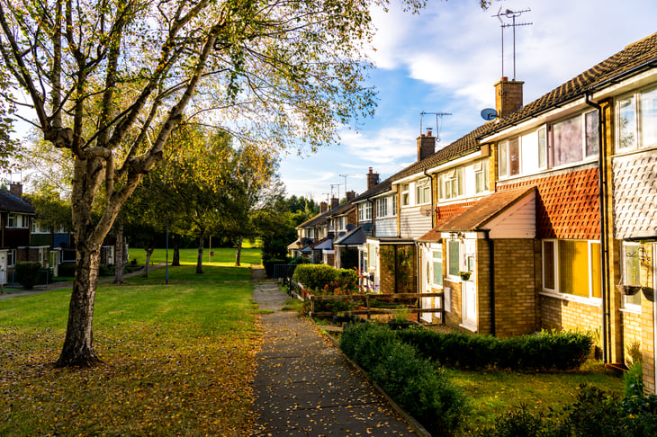 Row of houses in front of grass field
