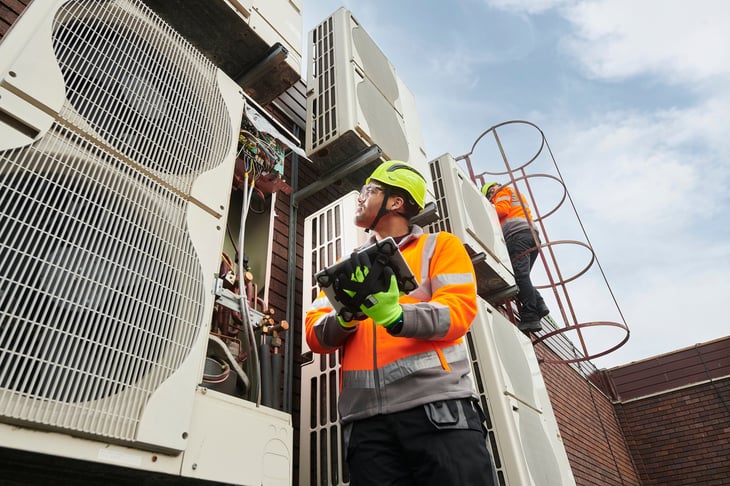 Stock image - man servicing equipment