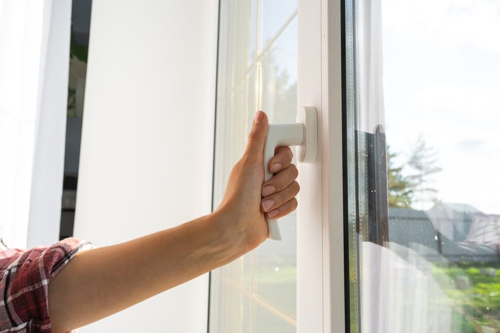 Stock image - hand opening door handle