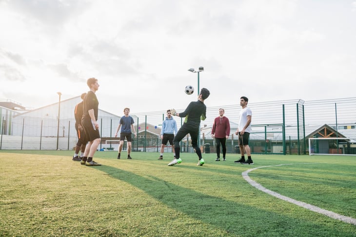 Boys playing football on a sports pitch
